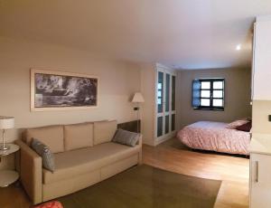 a living room with a couch and a bed at Villa Cudillero - recep H Isabel in Cudillero +42 photos