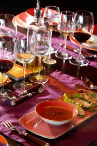 a table with wine glasses and a plate of food at Clos Apalta Residence Relais & Chateaux in Santa Cruz