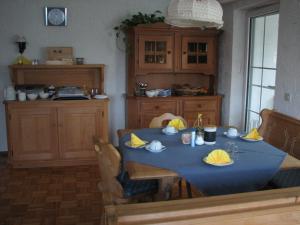 a dining room table with a blue table cloth on it at Gästehaus Alpenland in Halblech
