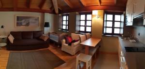 a living room with a couch and a table at Villa Cudillero - recep H Isabel in Cudillero