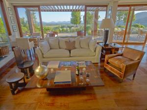 a living room with a couch and a table at Clos Apalta Residence Relais & Chateaux in Santa Cruz