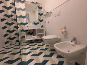 a bathroom with a toilet and a sink at Sorrento Flats in Sorrento