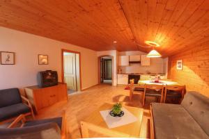 a living room with a couch and a table at Pension Kröll in Sankt Jakob in Defereggen