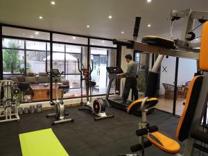 a man standing in a gym with a treadmill at Hotel Middle Path & Spa in Pokhara