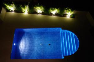 a blue lighted swimming pool at night with lights at Holiday home ''Oasi'' in Pula