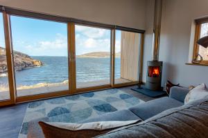 a living room with a view of the ocean at Tigh na Mara in Ullapool