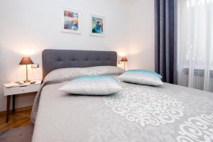a bedroom with a bed with two pillows on it at Studio Apartment Noah in Rovinj