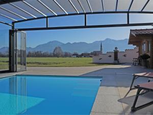 a swimming pool with a view of the mountains at Gemütliches Ferienwohnung in Feldwies mit Sauna in Übersee +32 photos