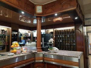 a wine bar with a clock on the wall at Hotel le Dauphin in Ajaccio