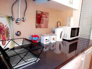 a kitchen counter with several microwaves and appliances on it at Apartament's Veiga Tejo in Lisbon