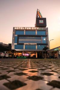 a building with a clock on the top of it at Hotel Fun City in Navsāri