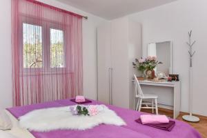 Postel nebo postele na pokoji v ubytování Apartmani Miluška