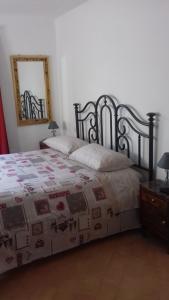 a bedroom with a bed and a mirror on the wall at Casa Galli in Castel Giorgio