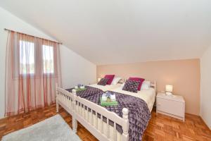 Postel nebo postele na pokoji v ubytování Apartmani Miluška