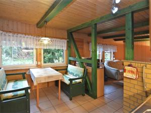 a living room with a table and a couch in a house at Harz Home with Outdoor Space in Ilfeld