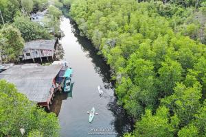 an aerial view of a river with two boats in it at Escape Life Koh Kood in Ko Kood