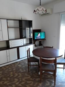 a living room with a table and a tv at Dalla Maria in Rimini