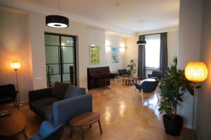 a living room with a couch and chairs and a piano at HOTEL SABU in Tbilisi City