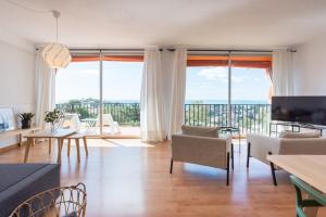 uma sala de estar com vista para o oceano em LU&CIA JARDIN AL MAR em Málaga