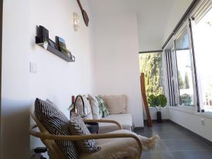 a living room with a chair and a couch at Pedras D'el Rei Waterfront Loft in Tavira
