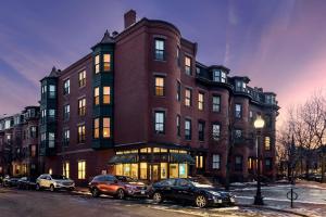 een groot bakstenen gebouw met auto's geparkeerd voor het bij Stylish Downtown Studio in the SouthEnd, C.Ave# 2 in Boston