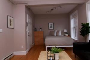 a bedroom with a bed and a dresser at Stylish Downtown Studio in the SouthEnd, C.Ave# 2 in Boston