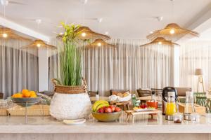 a living room with a table with fruits and vegetables at Clube Maria Luisa in Albufeira