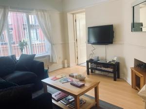 a living room with a couch and a coffee table at Be My Guest Liverpool - Ground Floor Apartment with Parking in Liverpool
