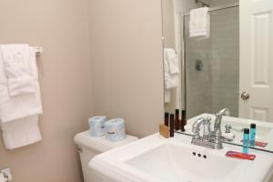 a white bathroom with a sink and a mirror at Stylish Downtown Studio in the SouthEnd, C.Ave# 3 in Boston