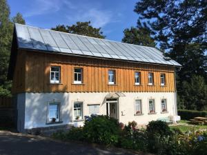 a house with solar panels on top of it at Dukát Kořenov in Kořenov