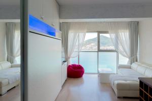 a living room with a view of the ocean at Harmonia Panorama Apartments in Budva