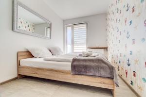 Posteľ alebo postele v izbe v ubytovaní Apartamenty Sun & Snow Kopernika
