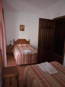 Postel nebo postele na pokoji v ubytování Apartamentos El Mirador