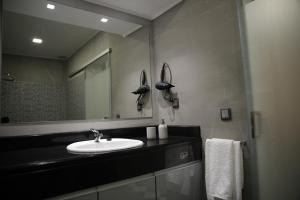 a bathroom with a sink and a mirror at Machim House by AnaLodges in Machico