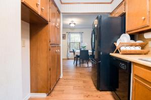 a kitchen with a black refrigerator and a table at Home away from Home No City Tax in San Antonio