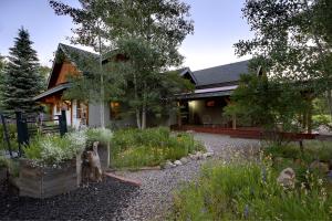a house with a garden in front of it at Mariposa Lodge Bed and Breakfast in Steamboat Springs