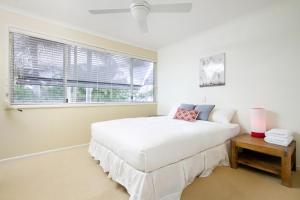 A bed or beds in a room at 6/75 Noosa Parade