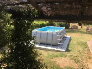 a hot tub in a yard with a ladder at Belvilla by OYO La Provincia in Sassa
