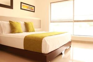 A bed or beds in a room at Aparta Suites La Flora