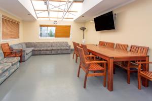 a living room with a table and chairs and a couch at BIG4 Ingenia Holidays Phillip Island in Newhaven