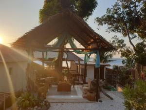 ein kleines Haus mit einem Strohdach in der Unterkunft Raya Del Sol Dive Resort in Mabini