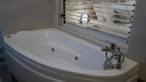 a bathroom sink with a faucet next to a window at Beach House in Plakias