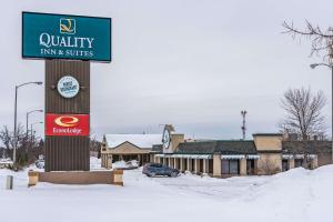 a sign for auryury inn and suites in the snow at Quality Inn & Suites in Brainerd