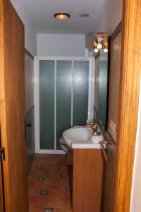 a bathroom with a sink and a toilet in it at Casa Rural Benito in Las Cuevas de Cañart