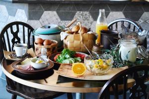 a table with a breakfast of eggs and food on it at Torget Aparthotel in Pori