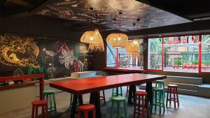 a restaurant with a wooden table and stools at Kitez Hotel & Bunkz in Kuala Lumpur