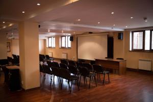 a large room with chairs and a projection screen at Alpen Ville in Almaty +59 photos