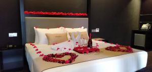a white bed with a heart made out of roses at Artworks Hotel Ipoh in Ipoh