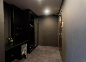 a hallway with a black wall and a door at Artworks Hotel Ipoh in Ipoh