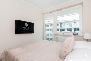 Posteľ alebo postele v izbe v ubytovaní Jantar Apartamenty Bliżej Morza